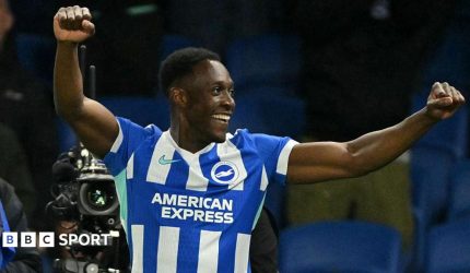 Danny Welbeck punches the air with both hands after scoring for Brighton